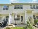 A house's backyard area includes a closed door, window, patio umbrella, and air conditioning unit at 111 Grey Elm Trl, Durham, NC 27713
