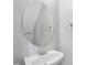 Simple bathroom with pedestal sink, round mirror, and neutral decor at 111 Grey Elm Trl, Durham, NC 27713