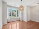 Bright dining area with hardwood floors, large windows, and stylish lighting at 111 Grey Elm Trl, Durham, NC 27713