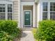 Inviting home entrance featuring a green front door and well-manicured landscaping at 111 Grey Elm Trl, Durham, NC 27713