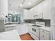 Modern white kitchen with stainless steel appliances and sleek countertops at 111 Grey Elm Trl, Durham, NC 27713