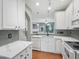 Well-appointed kitchen with white cabinets, stylish backsplash, and modern fixtures at 111 Grey Elm Trl, Durham, NC 27713