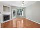 Bright living room with hardwood floors, fireplace, and large windows offering natural light at 111 Grey Elm Trl, Durham, NC 27713