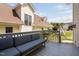 Exterior view of a back deck with a gray sofa and a small table at 112 Homegate Cir, Apex, NC 27502
