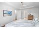 Bright bedroom with hardwood floors, white walls, ceiling fan, and decor at 112 Homegate Cir, Apex, NC 27502