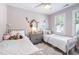 Spacious bedroom featuring two twin beds, neutral walls, hardwood floors, and natural light at 112 Homegate Cir, Apex, NC 27502