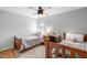 Cozy bedroom featuring two twin beds, neutral walls, hardwood floors, and natural light at 112 Homegate Cir, Apex, NC 27502