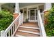 Inviting front porch with stained wood floors, white railings, and access to the front door at 112 Homegate Cir, Apex, NC 27502