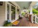 Inviting front porch with stained wood floors, comfortable seating, and a calming ceiling fan at 112 Homegate Cir, Apex, NC 27502