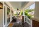 Covered front porch with a ceiling fan, outdoor seating, and a welcome mat at 112 Homegate Cir, Apex, NC 27502