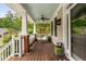 Relaxing front porch with stained wood floors, white railings, ceiling fan, and a swinging chair at 112 Homegate Cir, Apex, NC 27502
