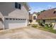Exterior of attached two car garage with driveway and swing set in the yard at 112 Homegate Cir, Apex, NC 27502