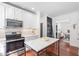 Well-lit kitchen featuring stainless steel appliances, island, and lots of cabinets at 112 Homegate Cir, Apex, NC 27502