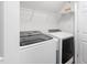 Convenient laundry room featuring modern washer and dryer units and ample storage shelving at 112 Homegate Cir, Apex, NC 27502