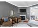 Cozy living room with a fireplace, comfortable seating, and elegant decor at 112 Homegate Cir, Apex, NC 27502