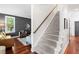 Inviting living room featuring hardwood floors, stylish furniture, and ample natural light from the large window at 112 Homegate Cir, Apex, NC 27502