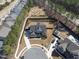 An aerial view of a meticulously landscaped home in a tranquil neighborhood near a forest at 113 Amberwing Ct, Holly Springs, NC 27540