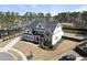 Aerial view showcasing a stunning home with mature trees and well-maintained yard in a suburban neighborhood at 113 Amberwing Ct, Holly Springs, NC 27540