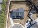 View of a well-maintained house featuring landscaped yard, play area, in-ground trampoline and fenced backyard at 113 Amberwing Ct, Holly Springs, NC 27540