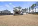 Expansive backyard with a covered patio, perfect for outdoor living and entertaining at 113 Amberwing Ct, Holly Springs, NC 27540