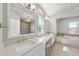 Primary bathroom with dual sinks, vanity and soaking tub and stylish tile work at 113 Amberwing Ct, Holly Springs, NC 27540