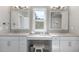 Bathroom with dual sink vanity, seating area and large window at 113 Amberwing Ct, Holly Springs, NC 27540