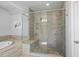 Stylish bathroom featuring a luxurious glass-enclosed shower and soaking tub at 113 Amberwing Ct, Holly Springs, NC 27540