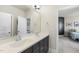 Spacious bathroom with double sinks, large mirror, and neutral tones for a calming atmosphere at 113 Amberwing Ct, Holly Springs, NC 27540