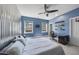 Unique bedroom features a corrugated metal accent wall, ceiling fan, and bright windows at 113 Amberwing Ct, Holly Springs, NC 27540