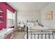 Colorful bedroom with a brick accent wall and a well-lit desk area at 113 Amberwing Ct, Holly Springs, NC 27540