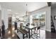 Bright dining area featuring wood floors, modern light fixture, and sliding glass doors to the outdoor deck at 113 Amberwing Ct, Holly Springs, NC 27540
