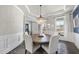 Bright dining room with a round table, white chairs, and a stylish chandelier at 113 Amberwing Ct, Holly Springs, NC 27540