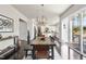 Open dining room with wood table and view of the kitchen at 113 Amberwing Ct, Holly Springs, NC 27540
