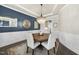 Elegant dining room features a round table, wainscoting, and modern chandelier at 113 Amberwing Ct, Holly Springs, NC 27540