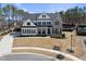 Stunning two-story home featuring a combination of white siding and brick, with a well-manicured lawn at 113 Amberwing Ct, Holly Springs, NC 27540