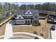 Beautiful two-story home with a manicured lawn, complemented by a stylish mix of siding and brick exterior at 113 Amberwing Ct, Holly Springs, NC 27540