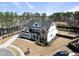 Aerial view of a two-story home with a dark roof, white siding, and well-maintained landscaping at 113 Amberwing Ct, Holly Springs, NC 27540