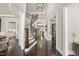 Inviting foyer featuring a curved staircase, wood floors, and open access to other rooms at 113 Amberwing Ct, Holly Springs, NC 27540