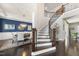 Elegant foyer with dark wood floors, curved staircase and dining room at 113 Amberwing Ct, Holly Springs, NC 27540