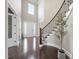 Spacious foyer with a soaring ceiling, hardwood floors, and a view of the staircase at 113 Amberwing Ct, Holly Springs, NC 27540