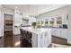 Beautiful kitchen featuring a large central island, modern lighting, and plenty of counter space at 113 Amberwing Ct, Holly Springs, NC 27540