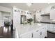 The kitchen has white cabinets, a central island, and stainless-steel appliances that create a modern and functional space at 113 Amberwing Ct, Holly Springs, NC 27540
