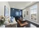 Cozy living room features natural light, dark wood floors, and stylish blue accent wall at 113 Amberwing Ct, Holly Springs, NC 27540