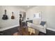 Inviting living room with dark wood floors, neutral sofa, and decorative guitars on the wall at 113 Amberwing Ct, Holly Springs, NC 27540