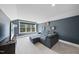 Comfortable living room with gray-blue walls, plush seating, and bright windows with tree views at 113 Amberwing Ct, Holly Springs, NC 27540