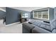 Cozy living room with gray-blue walls, plush carpet, and bright windows with black-out shades at 113 Amberwing Ct, Holly Springs, NC 27540