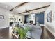 A modern living room features a fireplace, large gray couch, and natural light from a sliding glass door at 113 Amberwing Ct, Holly Springs, NC 27540