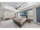 Bright main bedroom featuring a decorative ceiling, many windows, and comfortable seating at 113 Amberwing Ct, Holly Springs, NC 27540