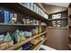 Walk-in pantry featuring built-in shelving and storage for organized food storage and supplies at 113 Amberwing Ct, Holly Springs, NC 27540