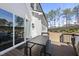 Outdoor patio featuring a dark table with bench seating, a grill, and a large sliding glass door at 113 Amberwing Ct, Holly Springs, NC 27540